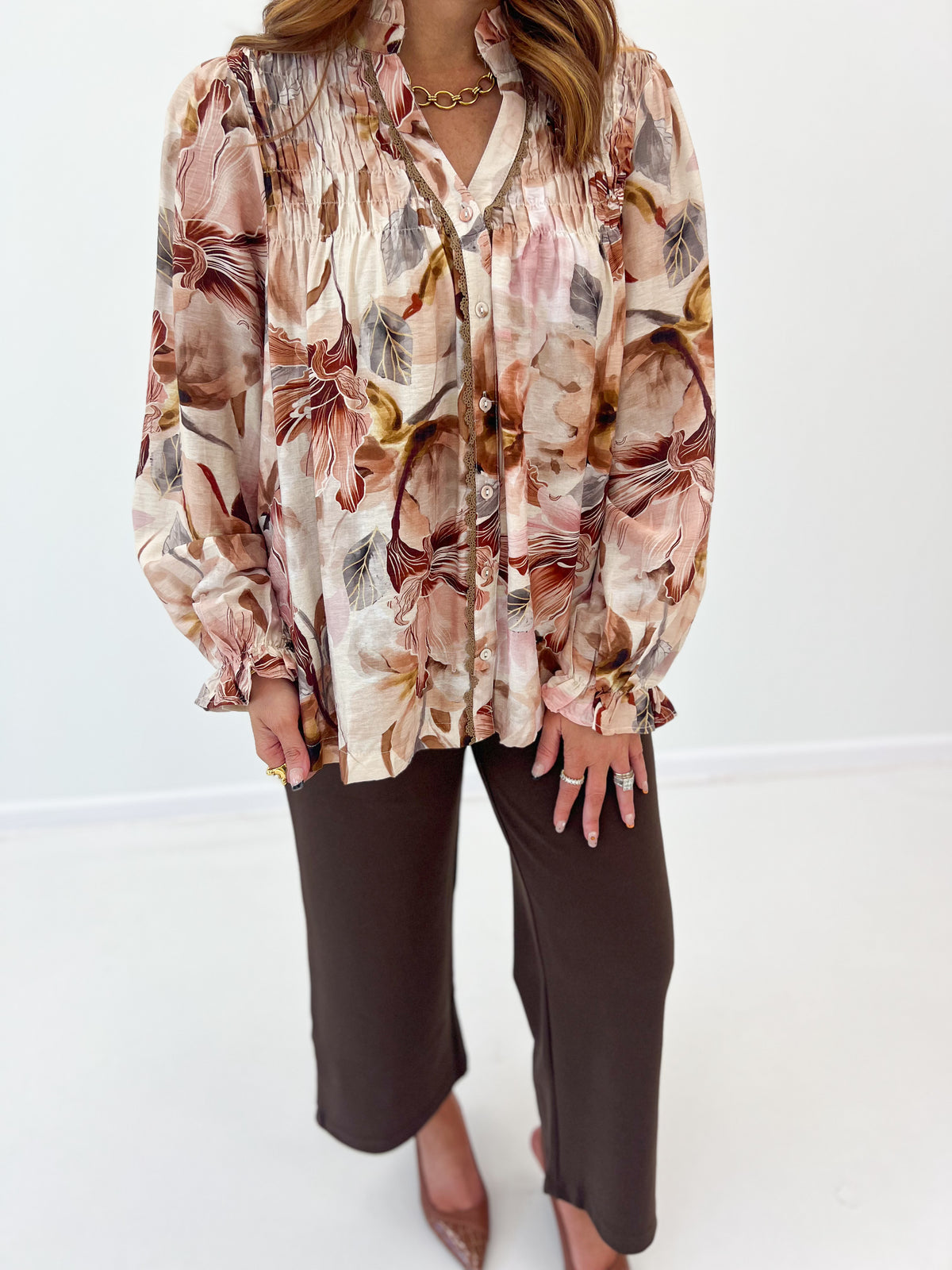 Brown mix floral print smocked blouse with long puff sleeves and button-front V-neck