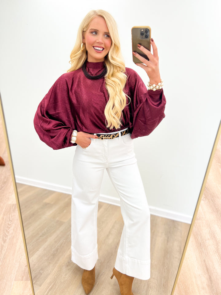 Burgundy polka dot high-neck blouse with long puff sleeves