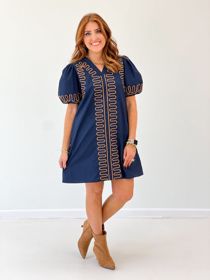 Navy short-sleeve embroidered dress with red stand-out center panel and cuffed sleeves