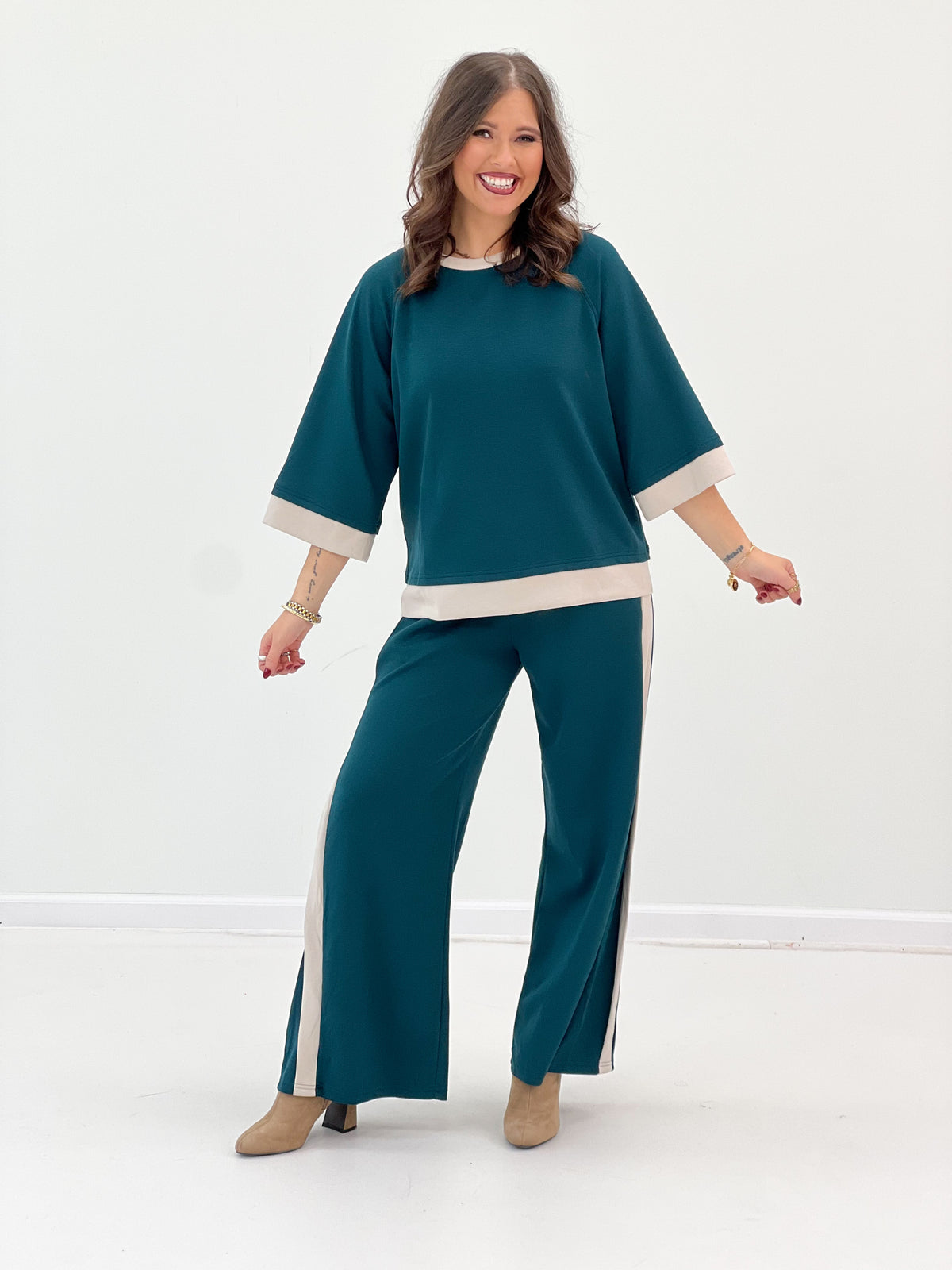 Women’s teal knit colorblock set with short cuff sleeves, cream hem band, and wide legs