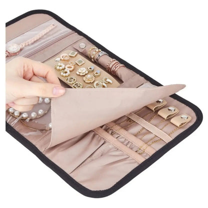Open jewelry organizer roll showing ring straps, earring panel and clear storage pockets