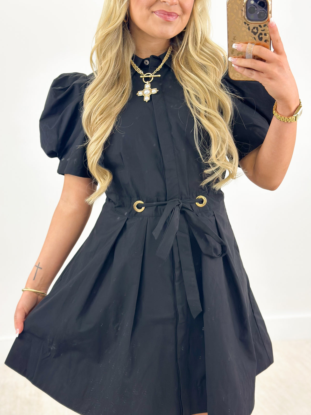 Black puff-sleeve tie-waist pleated mini dress with gold grommet belt