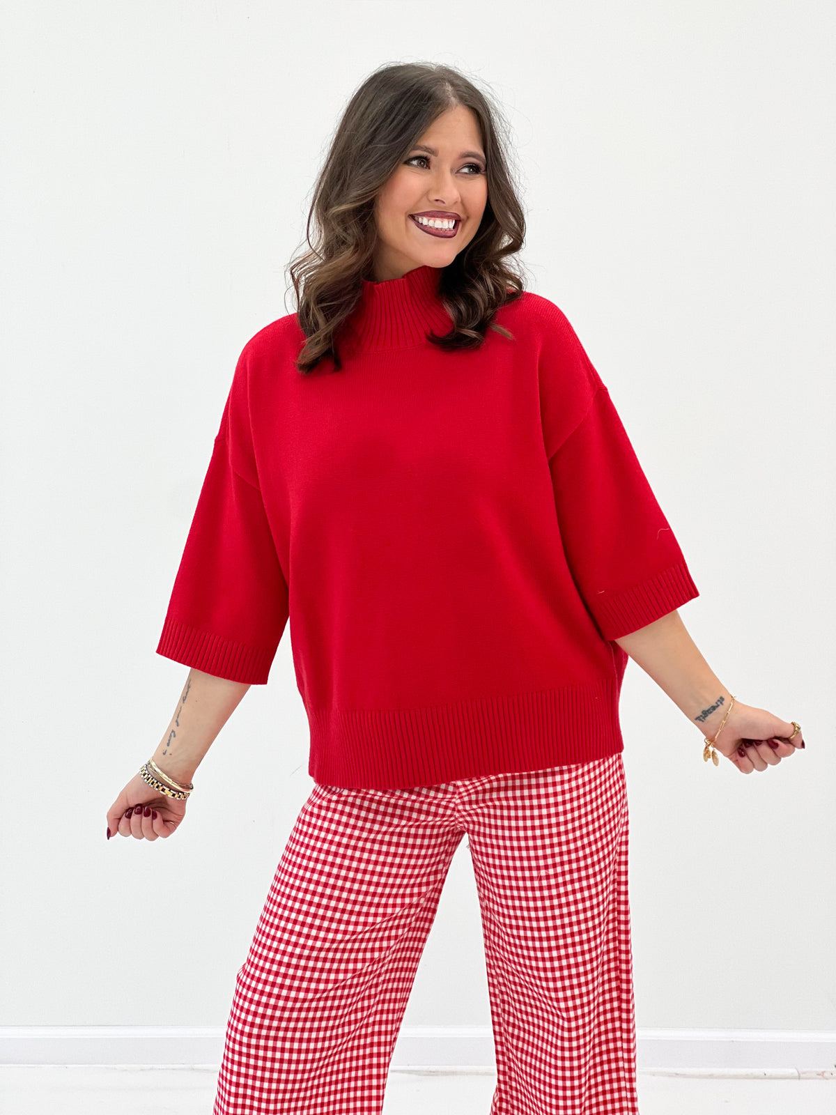 Red knit mock neck short-sleeve sweater with ribbed cuffs and hem