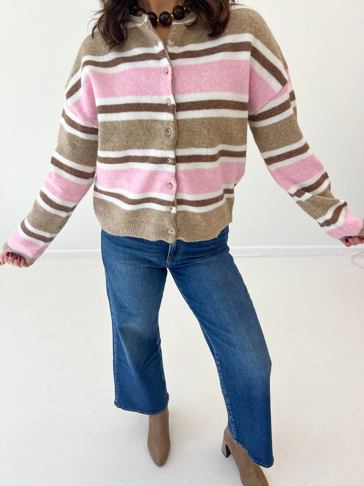Striped button-front cardigan in cream, pink, and brown with long sleeves