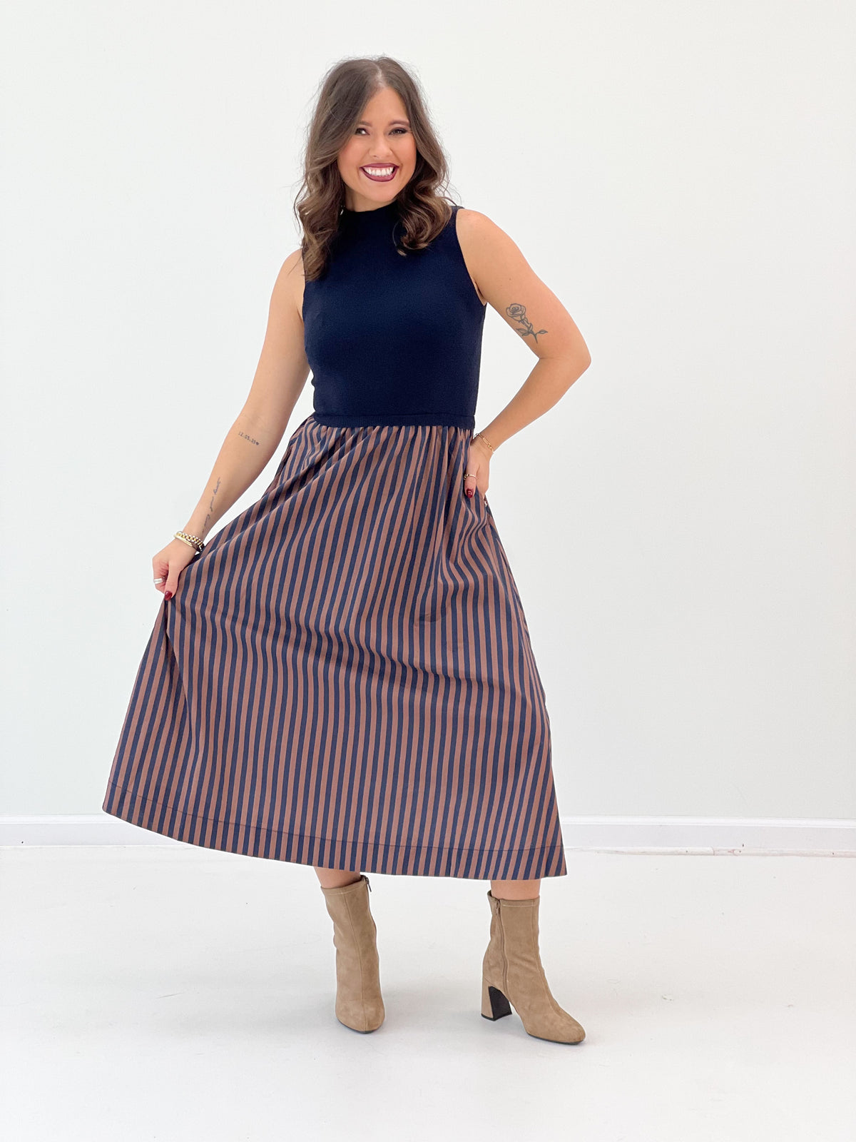 Navy sleeveless midi dress with gathered waist and vertical striped midi skirt
