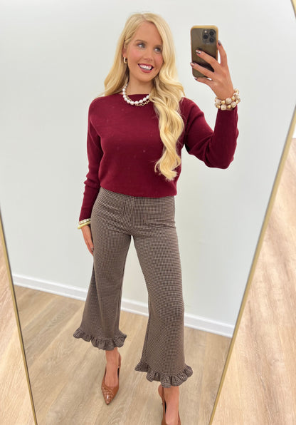 Mocha brown houndstooth pants with ruffle hem at the ankle and wide flare