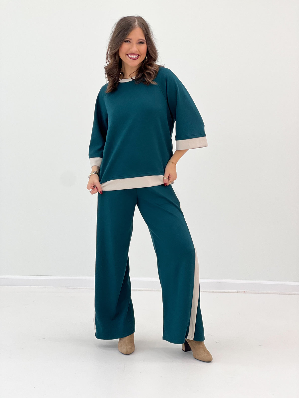 Women’s teal knit matching set: crewneck top and wide-leg pants with cream side stripe