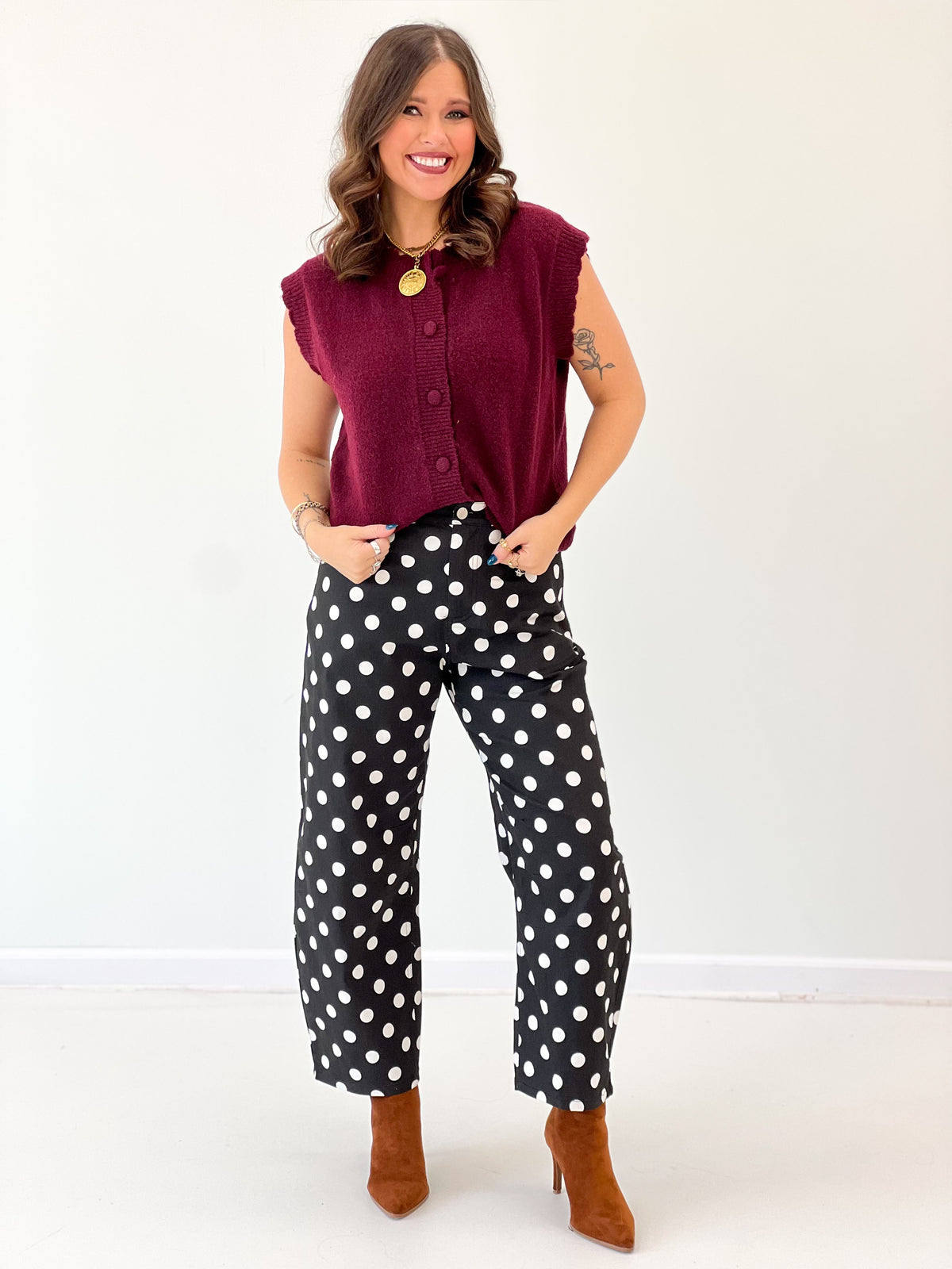 Burgundy ribbed button-down sweater vest with scalloped shoulders and front button placket