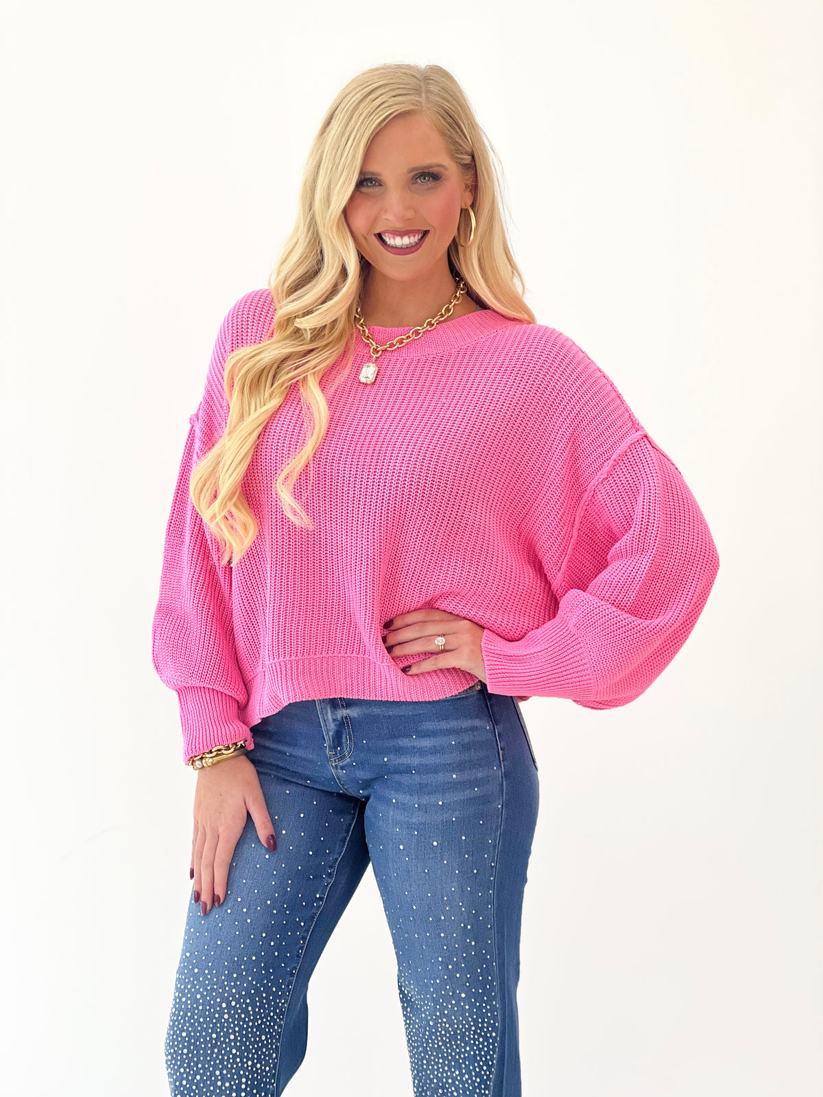 Pink oversized mock-neck sweater with long sleeves and knit texture