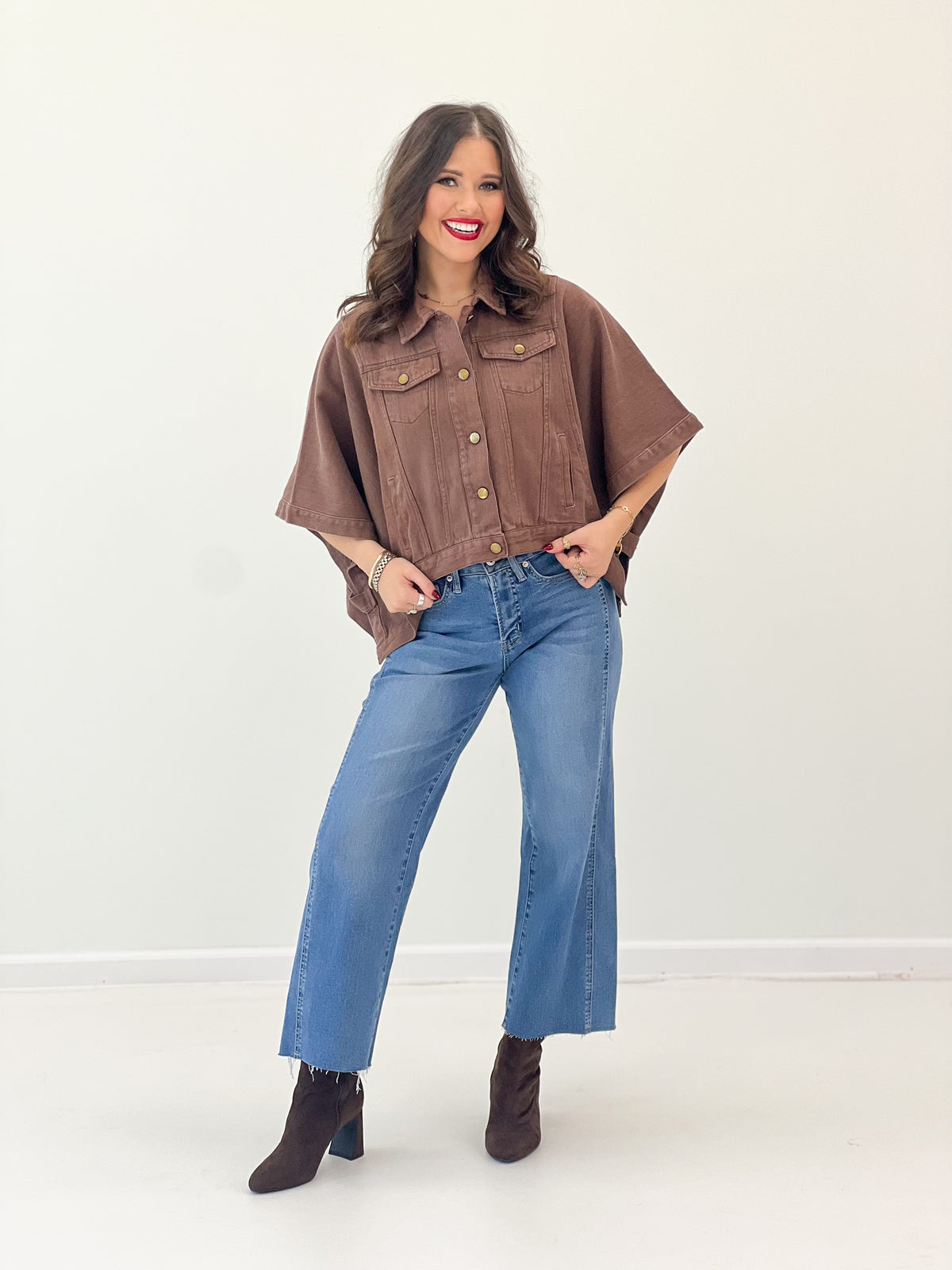 Brown short-sleeve snap-button denim jacket with two chest pockets, cropped fit