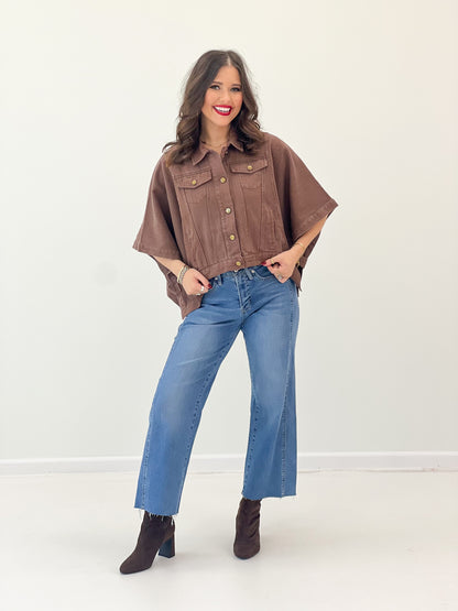 Brown short-sleeve snap-button denim jacket with two chest pockets, cropped fit