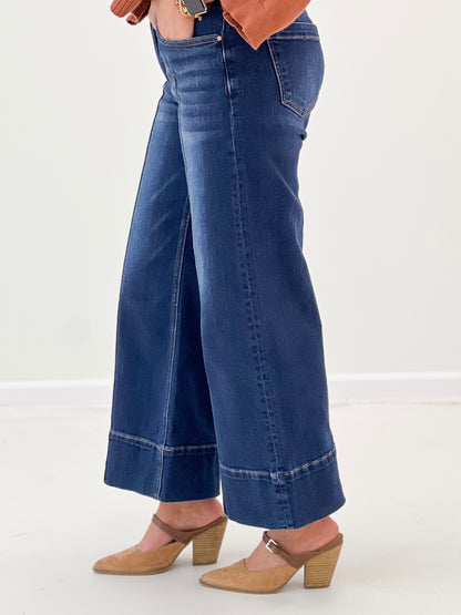 Mid-rise wide-leg crop jeans in dark blue with pintuck front and button closure