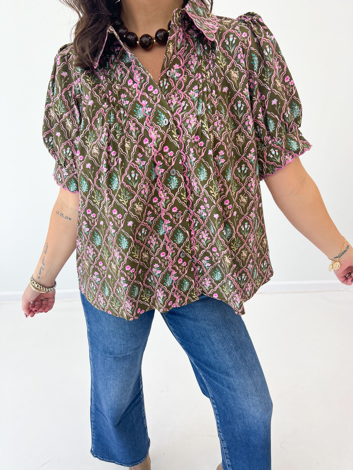 Close-up floral pintuck puff-sleeve V-neck top with textured front detail