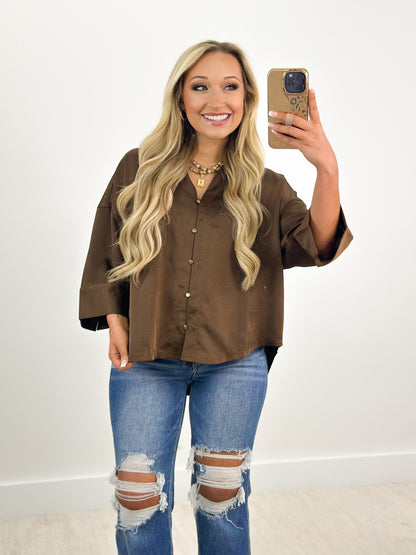 Brown V-neck button-down shirt with metal buttons and wide three-quarter sleeves