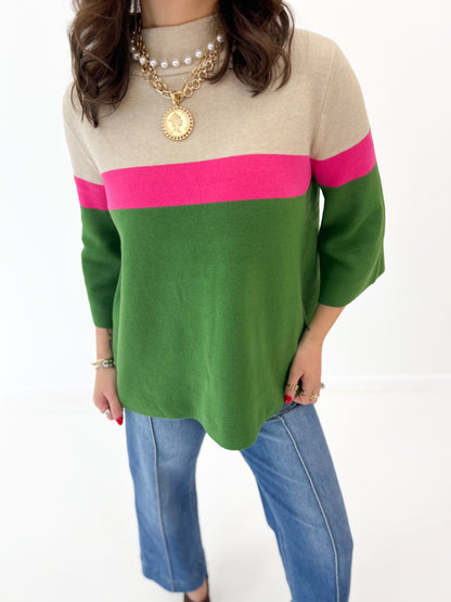 Color-block mock neck sweater with beige top, green body, and pink stripe band