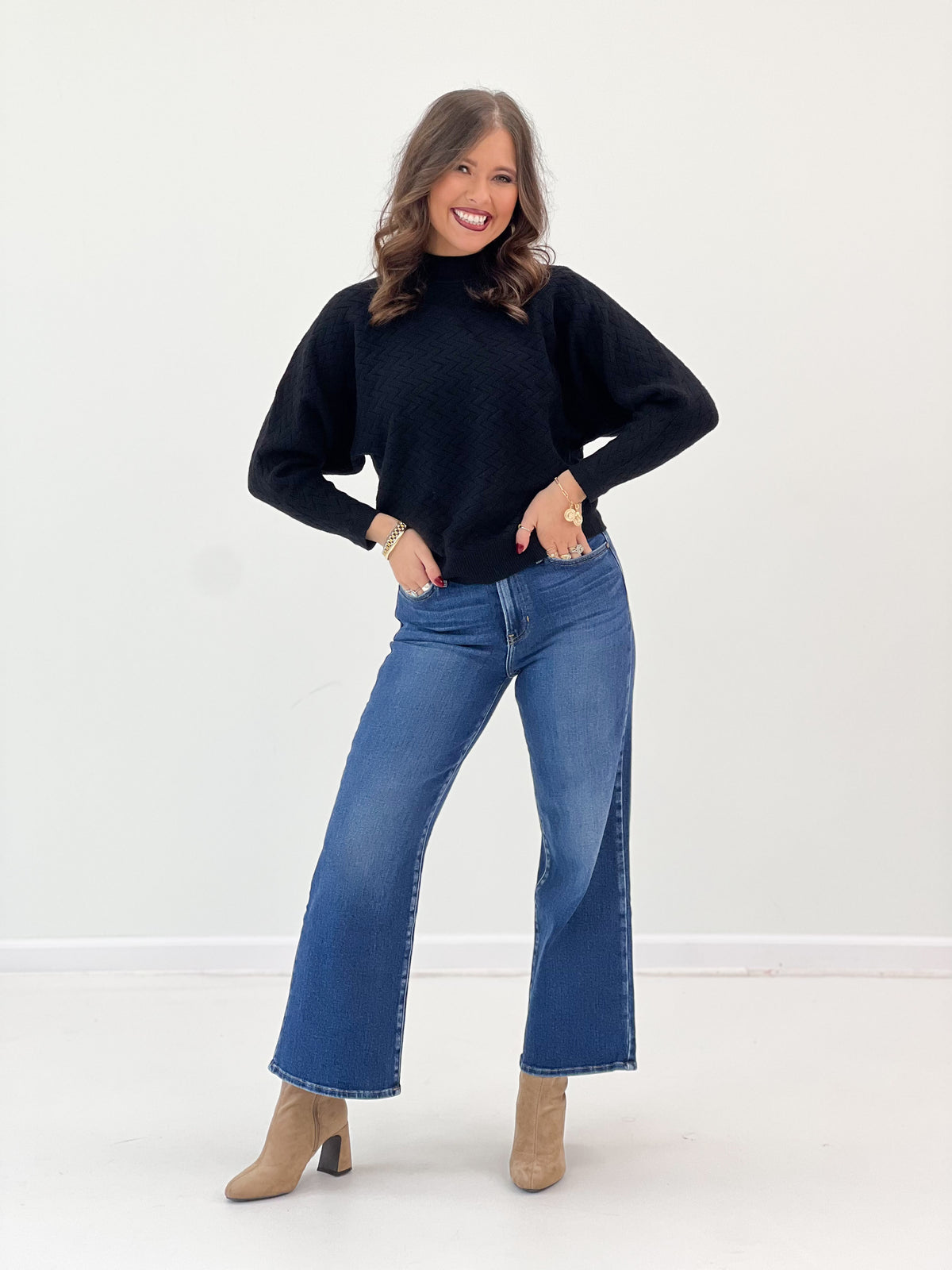 Black mock neck dolman knit sweater with relaxed shoulders and straight hem