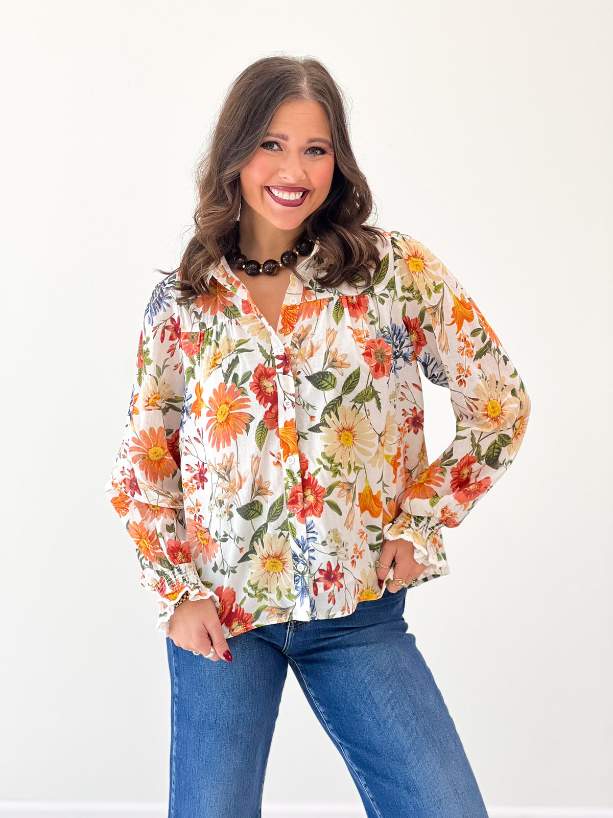 Floral print long-sleeve blouse featuring lace trim and button front, off-white with warm tones