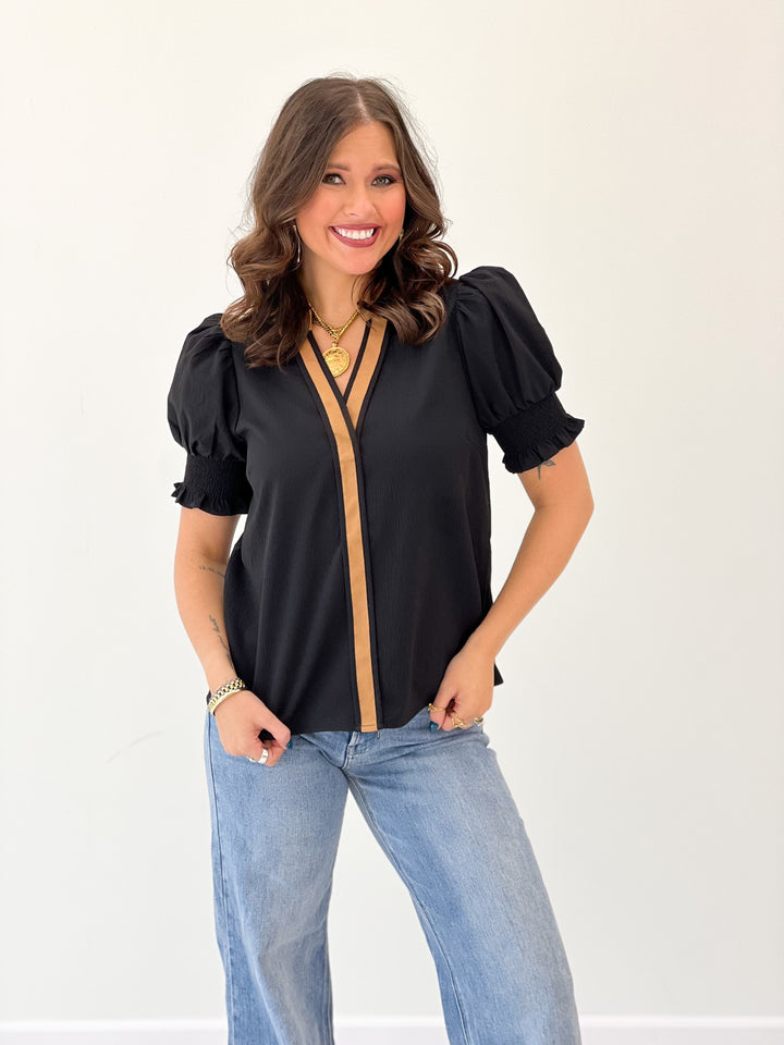 Black collared V-neck short-sleeve top with puff sleeves and vertical trim front
