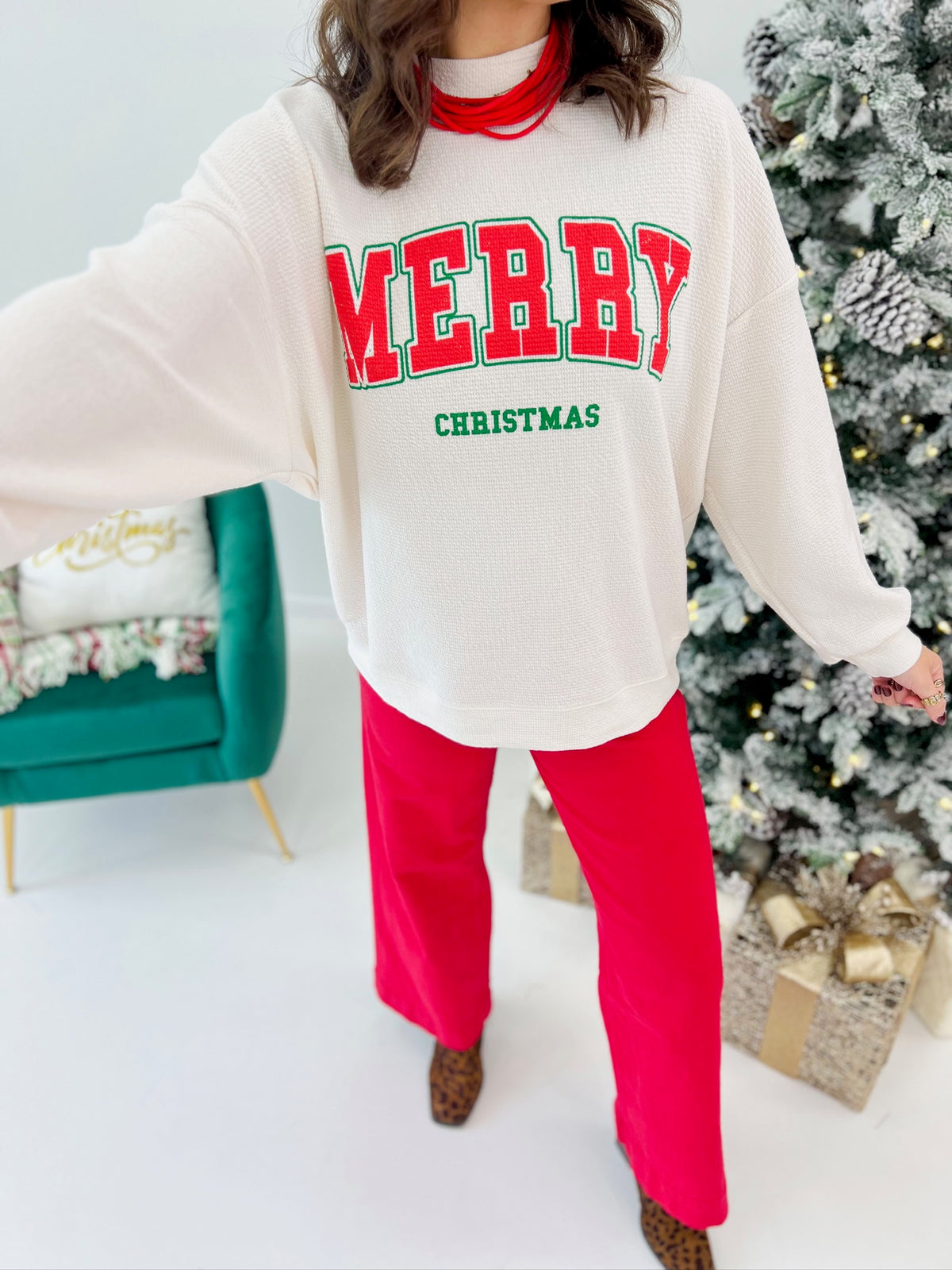 Cream knit long-sleeve top with 'MERRY' and 'CHRISTMAS' graphic front