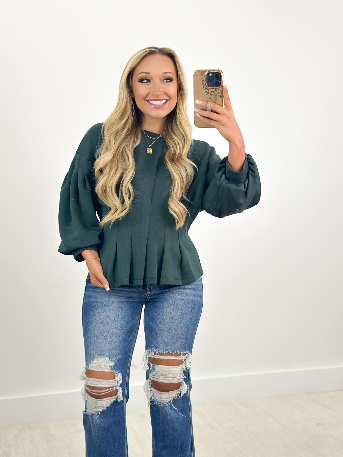 Forest green gathered long-sleeve peplum top with pleated waist and elastic cuffs