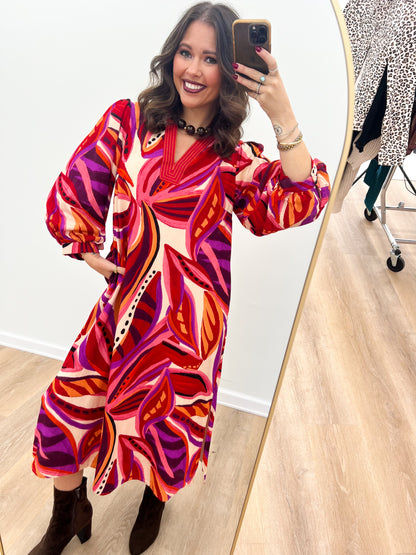 Red boho midi dress with V-neck, puff sleeves, and abstract swirl print