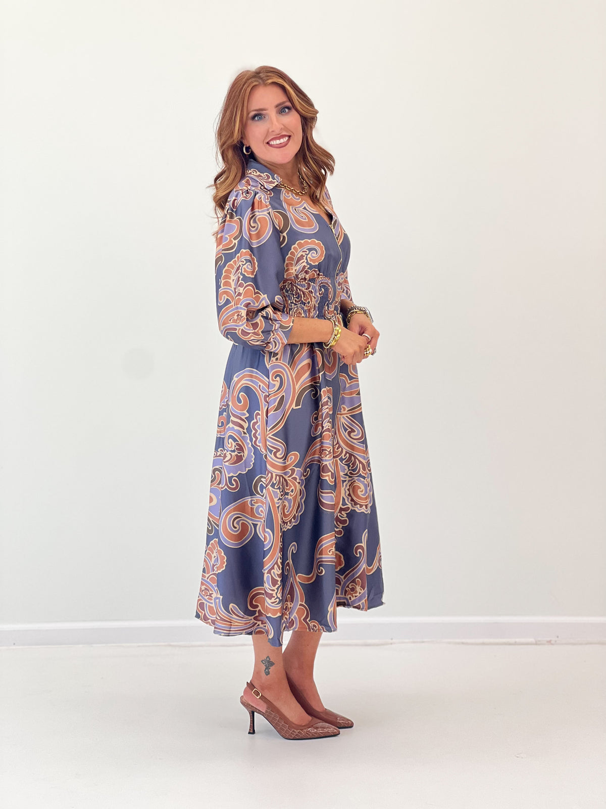Printed V-neck midi dress front view, slate grey mix with ornate swirls, smocked waist