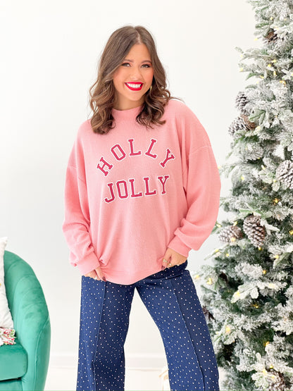 Pink knit Christmas sweatshirt with 'HOLLY JOLLY' graphic, crew neckline