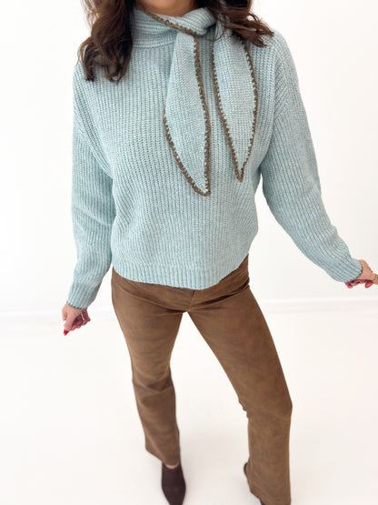 Dusty mint knit sweater with scarf-stitch detail and draped cord tie at neck