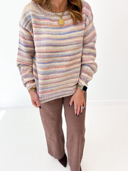 Close-up of multicolor striped wide-neck sweater knit with ribbed neckline