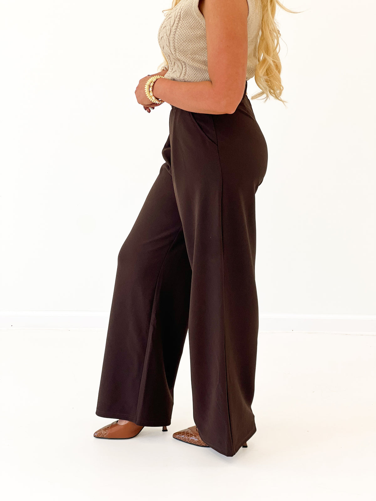 Dark brown belted pleated wide-leg pants, side view with straight wide hems