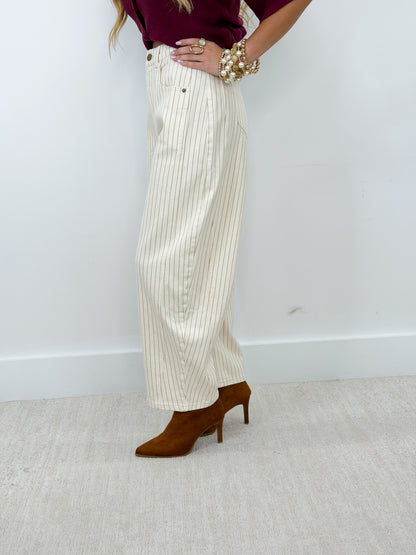 Cream pinstripe barrel pants with wide leg and front button closure, ankle length