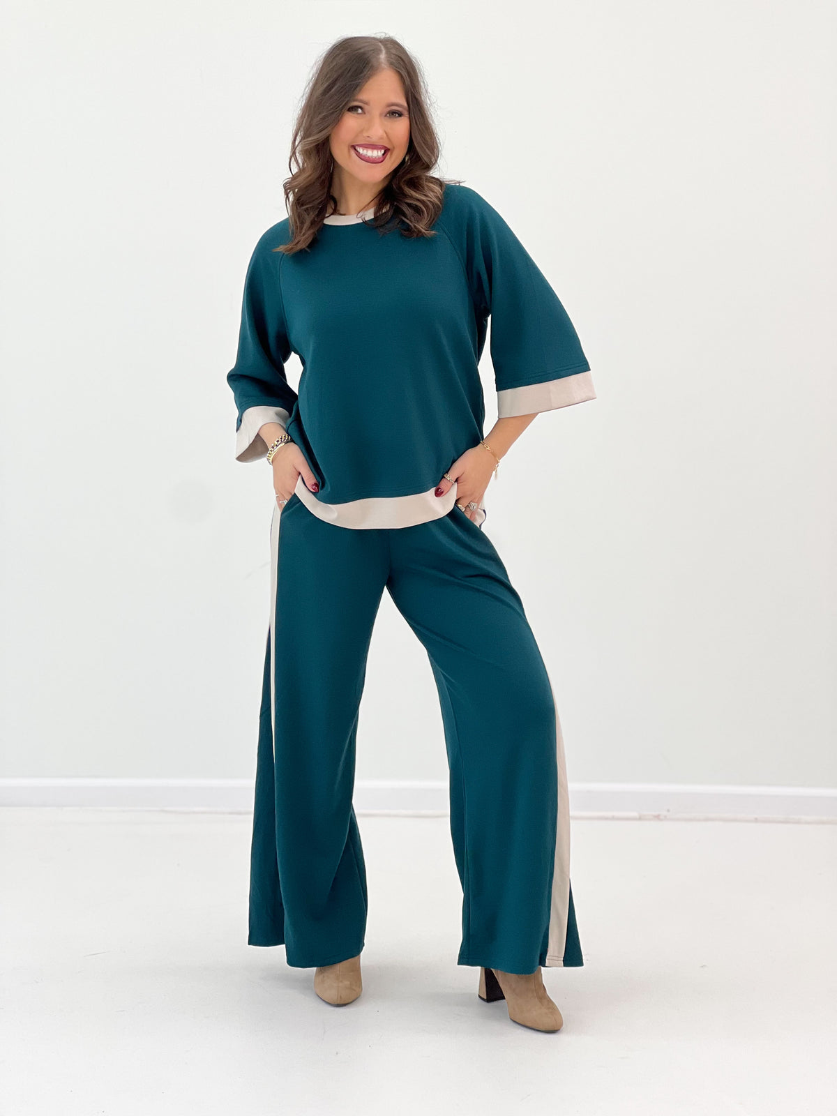 Women’s teal knit colorblock set with cream-trim sleeves and wide-leg pants side stripe
