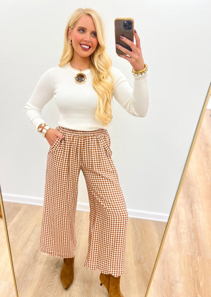 Red and white checkered wide-leg pants with elastic smocked waist and full-length drape