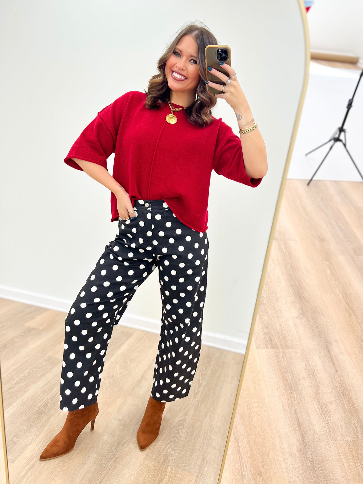 Black high-rise straight-leg polka dot pants with white dots, ankle length