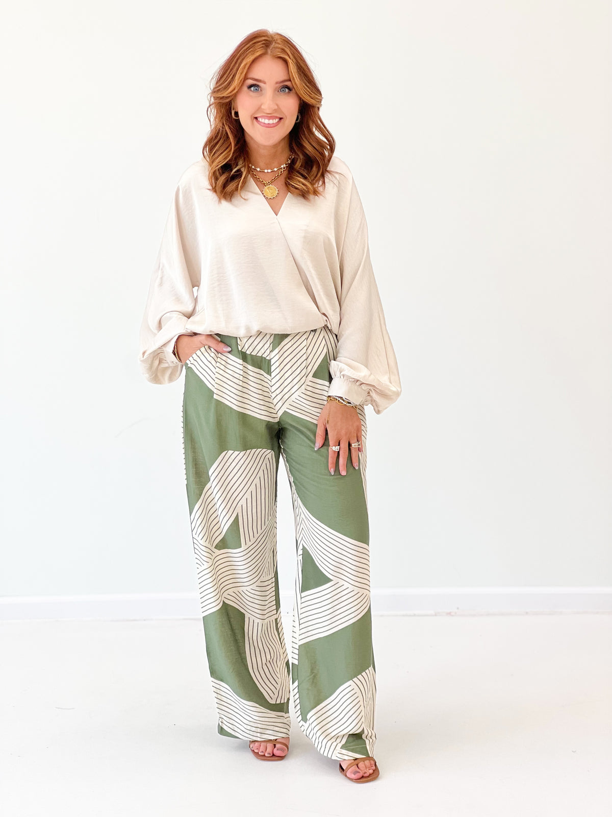 Olive green printed wide-leg pants with elastic waist and draped stripes