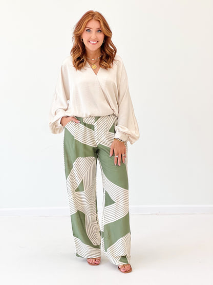 Olive green printed wide-leg pants with elastic waist and draped stripes