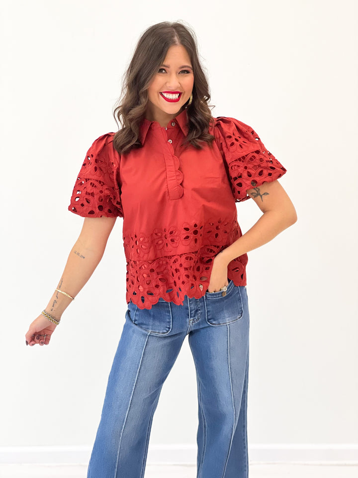 Rust eyelet puff-sleeve top with scalloped hem and allover cutout lace