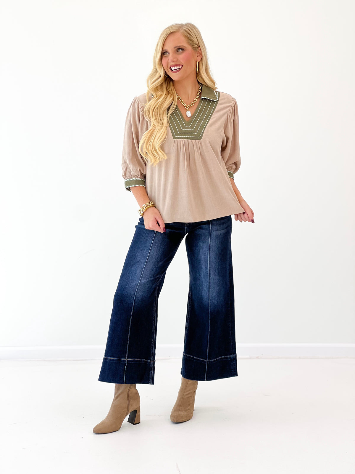 Stone linen blouse with green-trimmed V-neck and loose puff sleeves