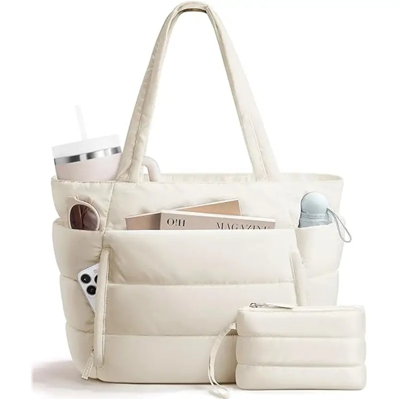 Cream puffer tote bag with front pocket, long padded handles, side pockets, and matching zip pouch