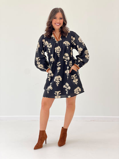 Black floral V-neck ruffle-collar dress with cuff sleeves, loose shift fit.