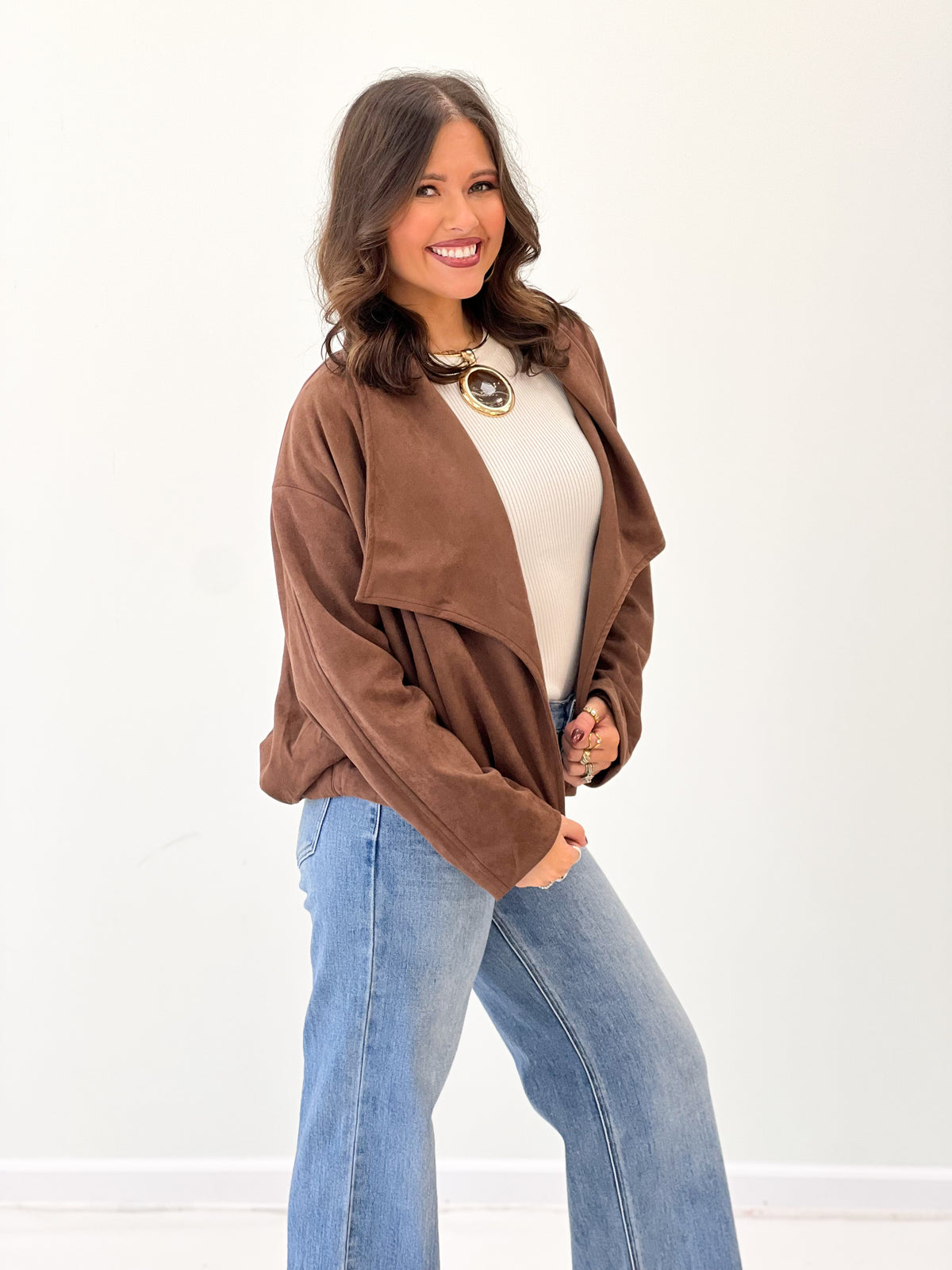Brown suede collared jacket with open front and relaxed loose sleeves