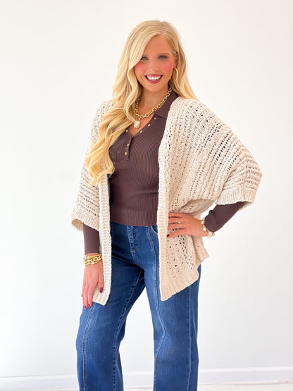 Oatmeal open-knit cardigan with long sleeves and textured open front