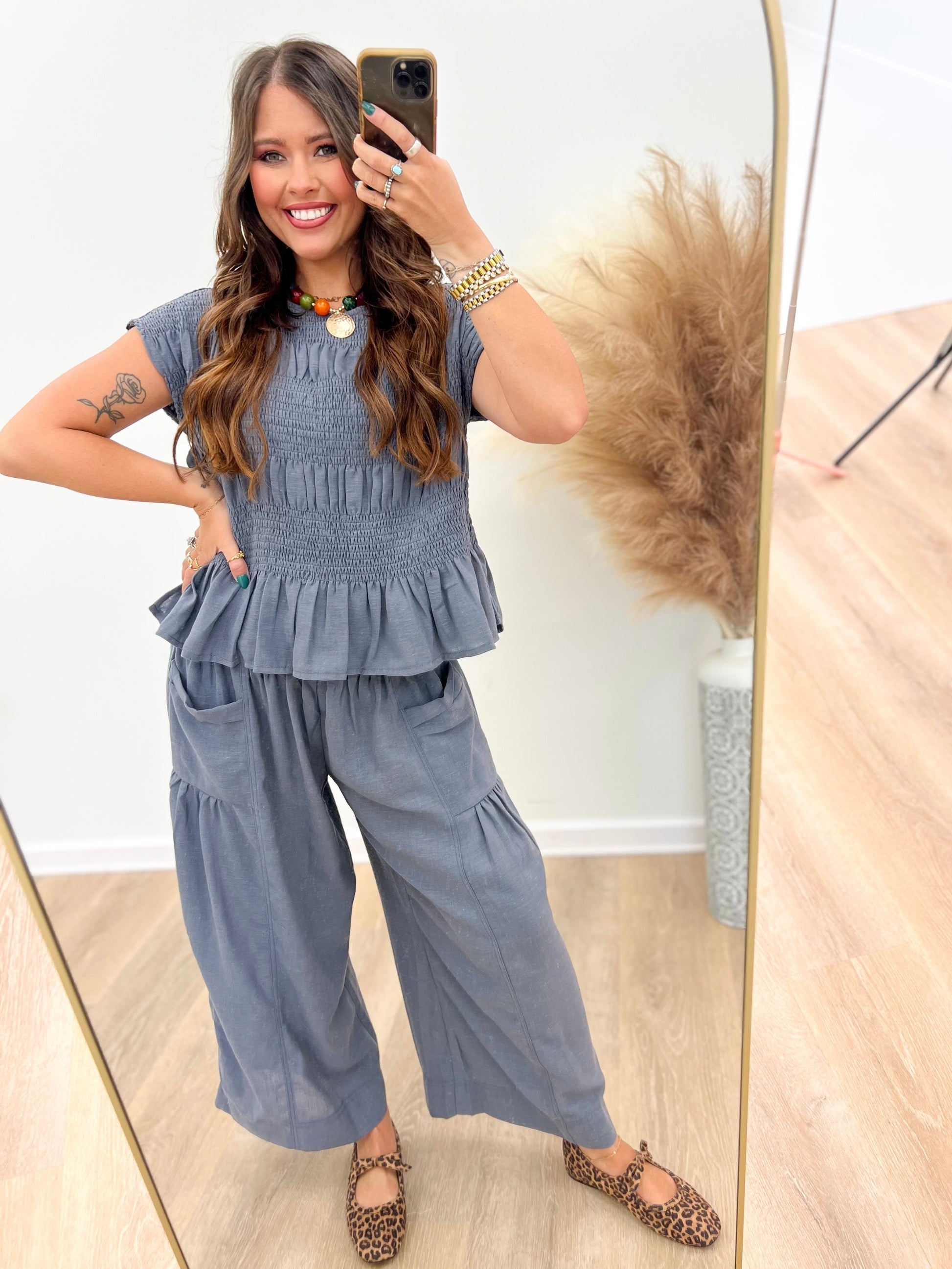 Deep blue ruched peplum top with short sleeves and gathered ruffle tiers