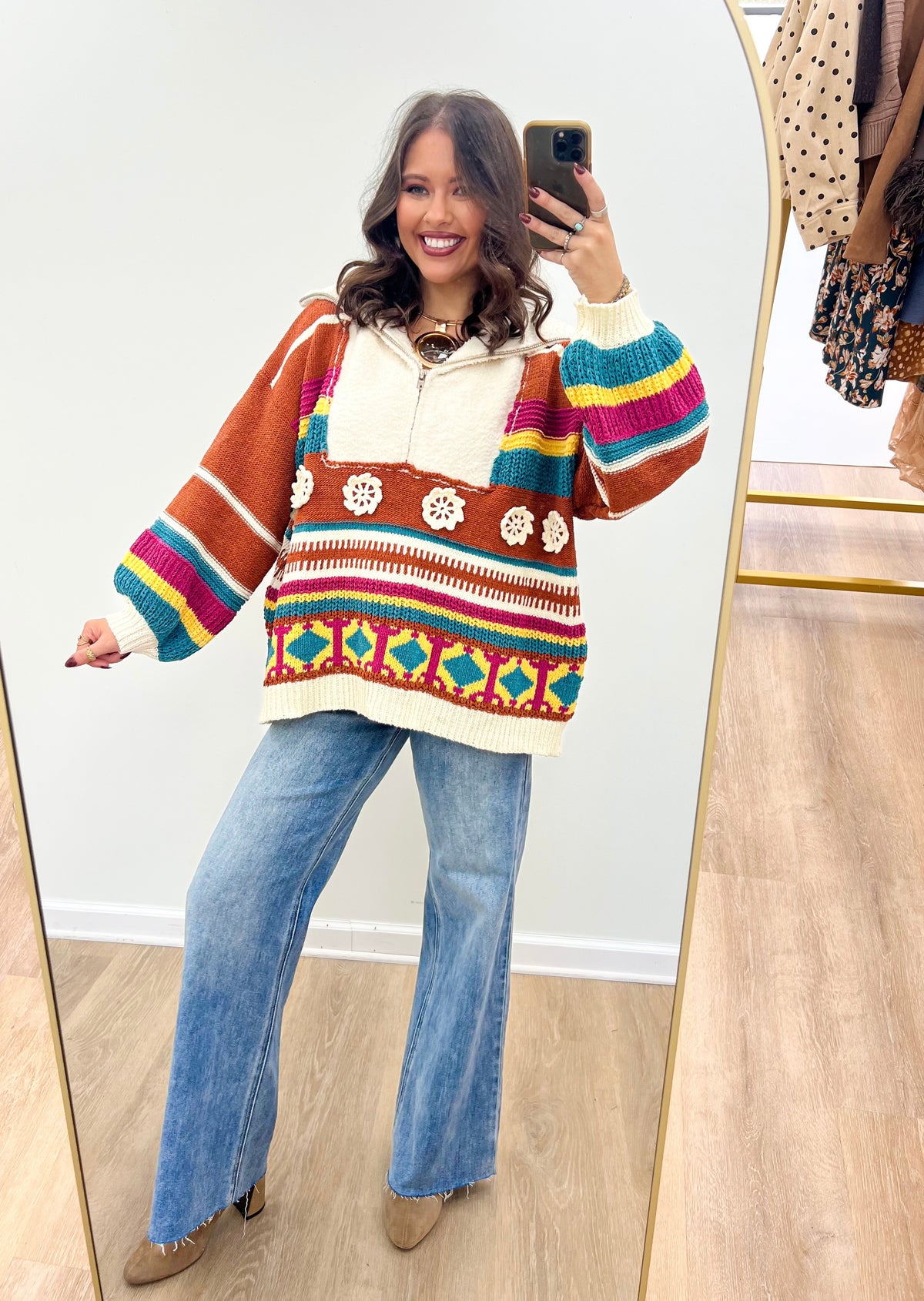 Brick multi hooded half-zip sweater with bold color blocks, striped yoke, and patterned hem