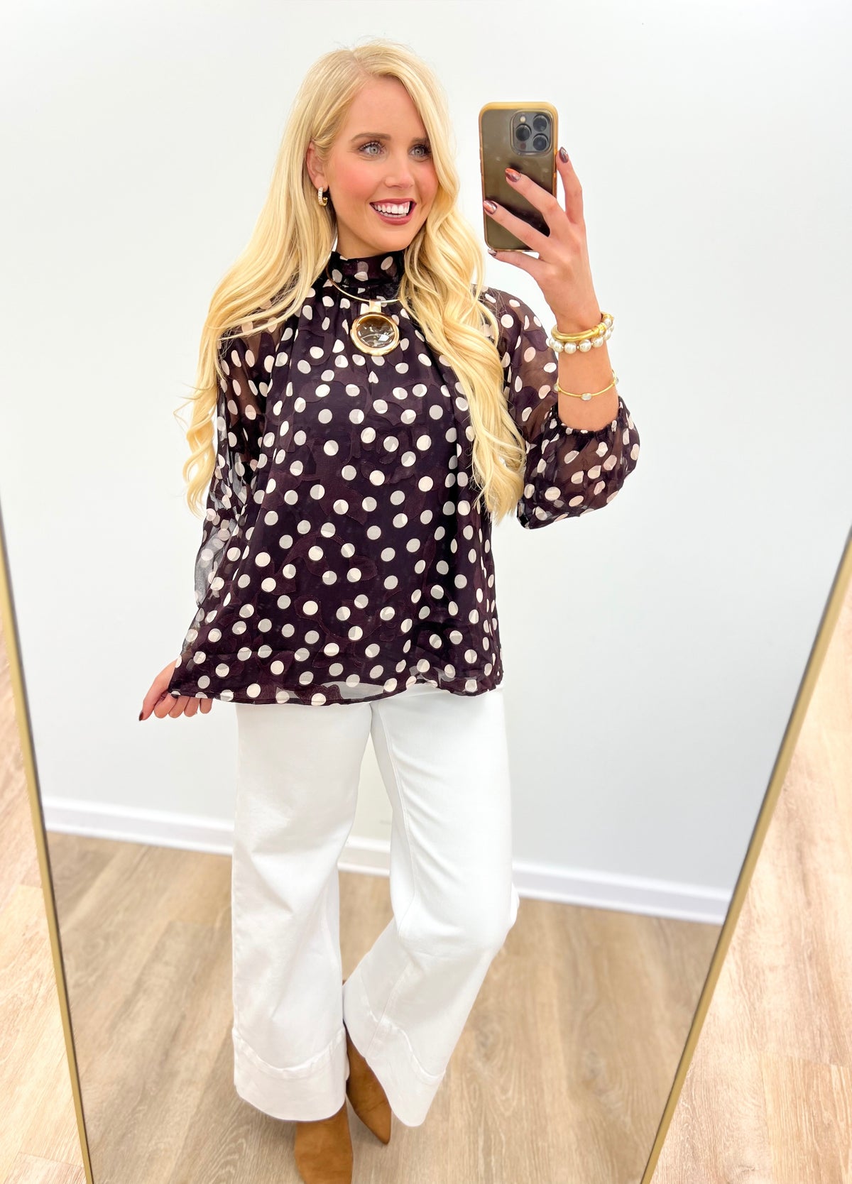 Black polka dot high-neck long-sleeve blouse with circular keyhole front detail