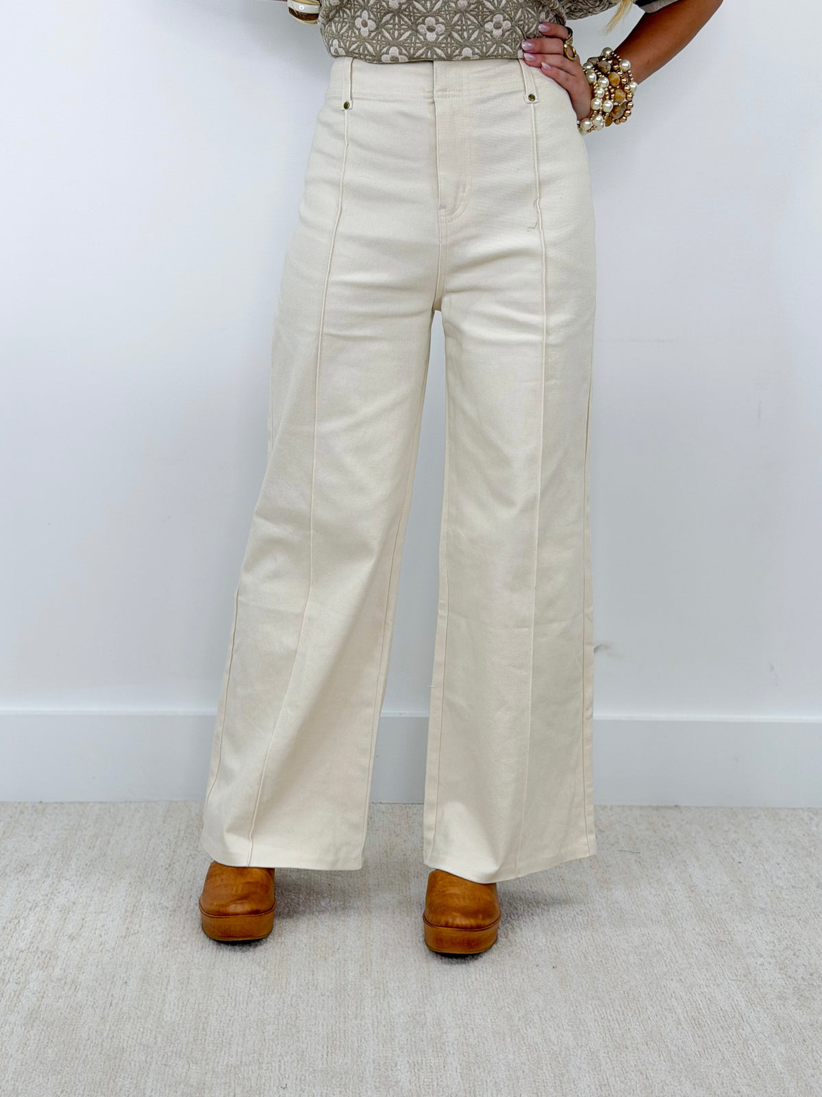 Off-white front-seam wide-leg pants with button front and front pockets