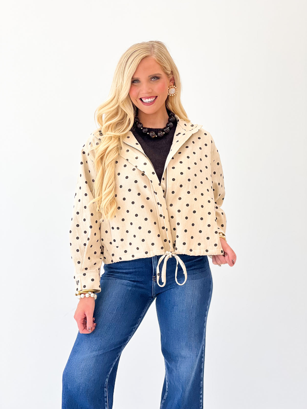 Ecru polka dot tie-front jacket with button placket and gathered drawstring waist hem