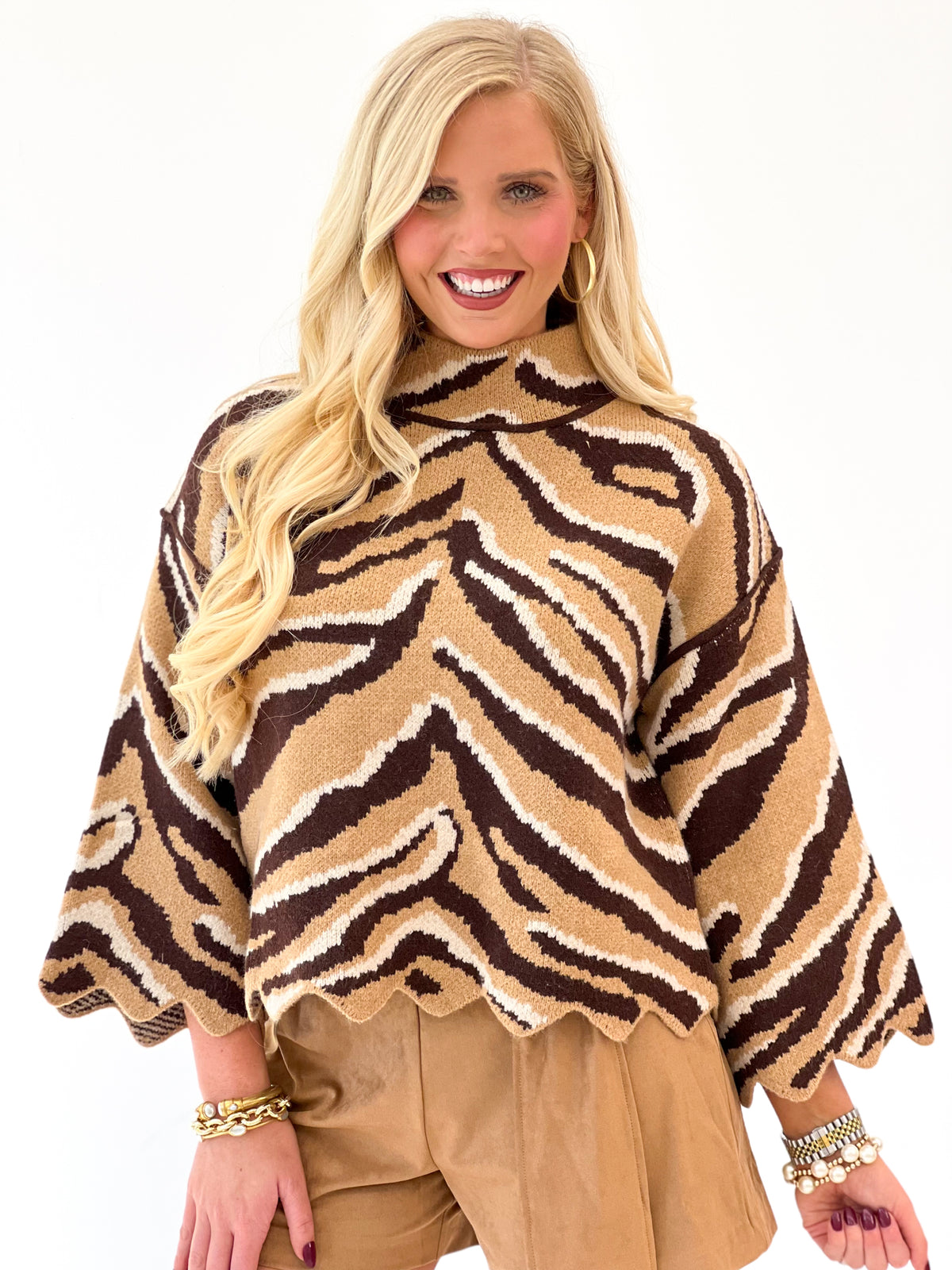 Animal print mock neck knit top with scalloped trim and relaxed dolman sleeves