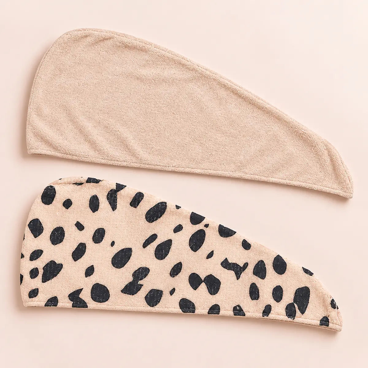CALA two-piece hair turban set with one solid beige wrap and one beige cheetah-print wrap.