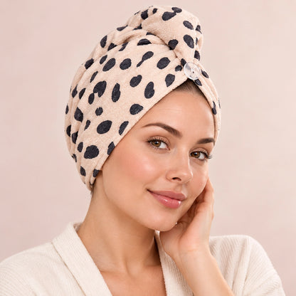 CALA cheetah-print hair turban in beige with a button closure, worn wrapped around the head.
